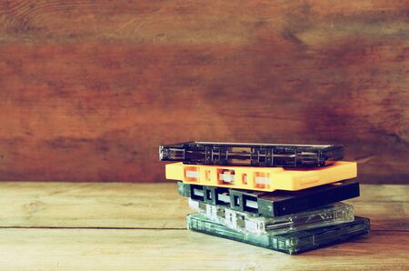 close up photo of stack of Cassette tapes over wooden table . retro style imageの写真素材