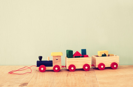 Wooden toy train over wooden tableの写真素材