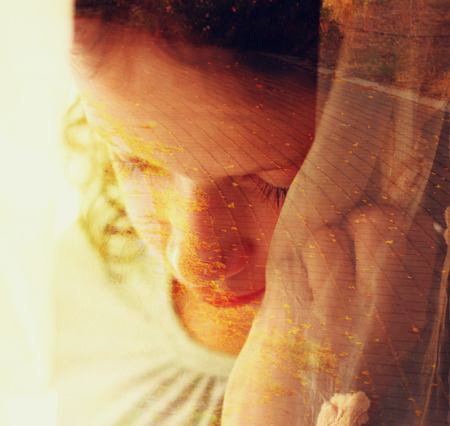 Double exposure of romantic nature landscape and cute happy kidの写真素材