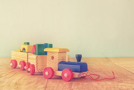Wooden toy train over wooden tableの写真素材