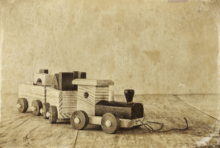 Wooden toy train over wooden floor. selective focus. black and white old style photoの写真素材