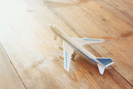 toy airplane over wooden textured table. retro style imageの写真素材