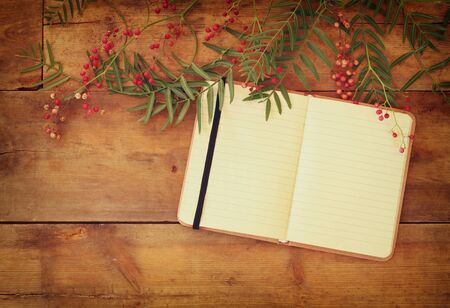 open blank vintage notebook over wooden table. ready for mockup. retro filtered imageの写真素材