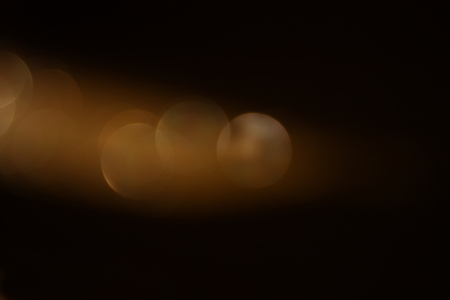 glitter vintage lights background. dark gold and black. defocusedの写真素材