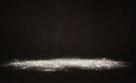 white powder blast over black textured backgroundの写真素材