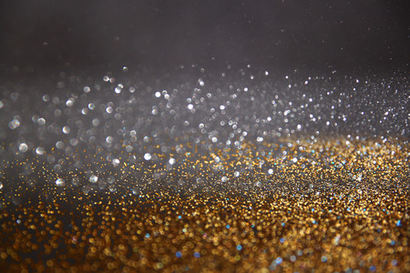 glitter vintage lights background. gold, blue and black. defocusedの写真素材