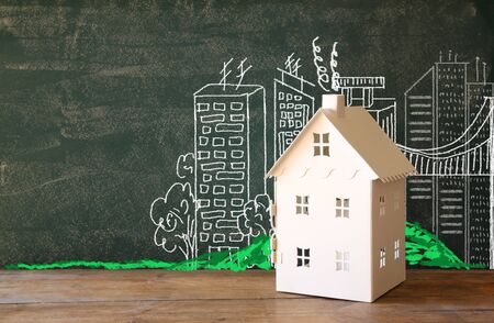 photo of house and background of blackboard and city drawings. real estate and family house conceptの写真素材
