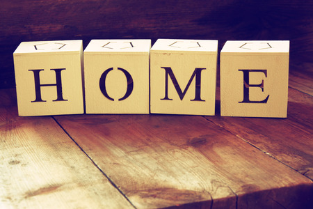 wooden cubes with the writing home over wooden table.の写真素材