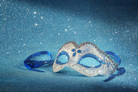 blue female carnival mask and glitter background. with glitter overlayの写真素材