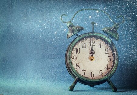 vintage clock over blue ice bokeh background. new year concept. selective focusの写真素材