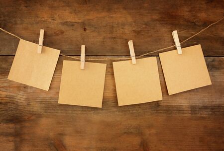 Blank tags hanging on wooden background