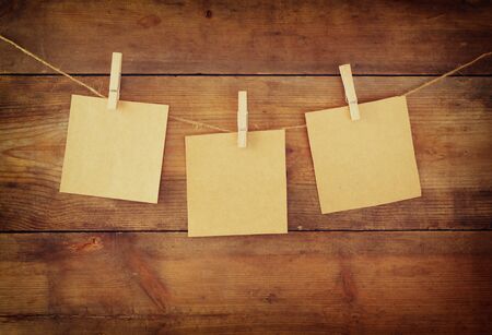 Blank tags hanging on wooden background