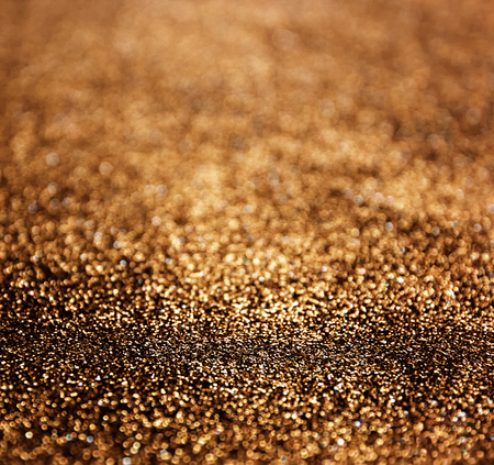 glitter vintage lights background. dark gold and black. defocusedの写真素材