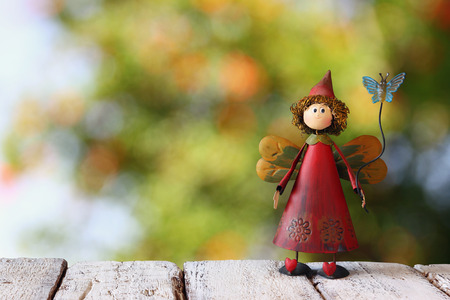 cute fairy on wooden table and blurred backgroundの写真素材