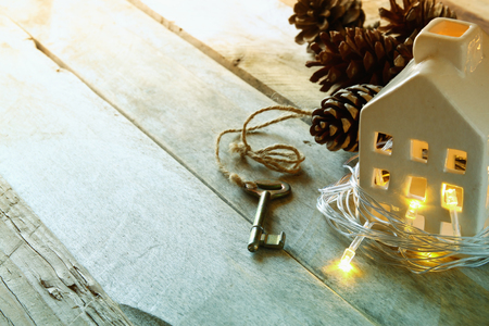 image of small miniature house and old key over rustic wooden table. filtered and tonedの写真素材