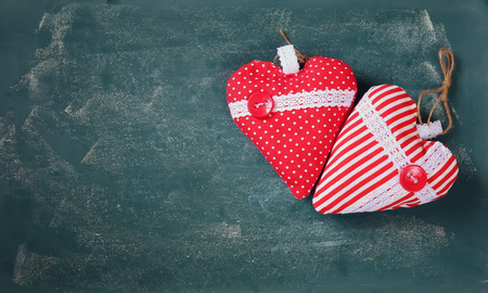 top view image of fabric hearts on blackboard background. valentine's day celebration conceptの写真素材