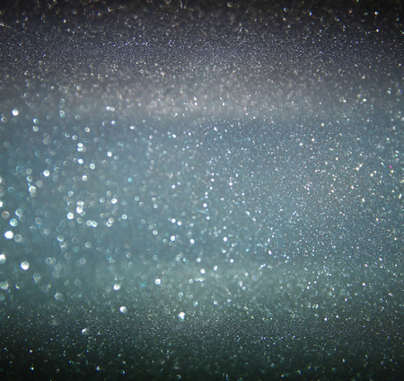 glitter vintage lights background. gold, silver, blue and black. de-focused.の写真素材