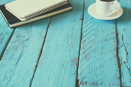 top view image of blank notebook next to cup of coffeeの写真素材