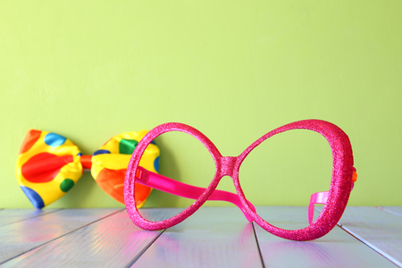 festival retro pink eyeglasses on wooden tableの写真素材