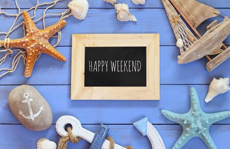 top view of nautical concept with chalkboard and text: HAPPY WEEKEND next to nautical life style objectsの写真素材