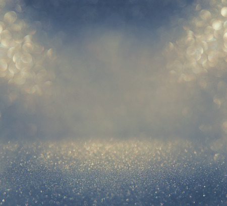 glitter vintage lights background. blue, silver and black. defocused.