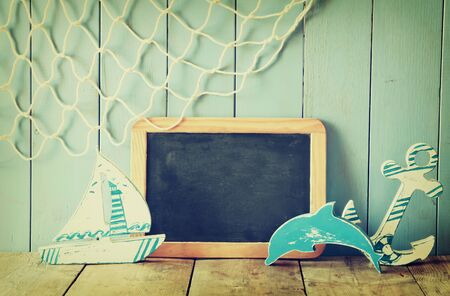 nautical life style objects and blank blackboard on wooden table. vintage filered and tonedの写真素材