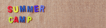 website banner image of colorful wooden letters with phrase: SUMMER CAMP on burlap canvas fabric background. vintage filteredの写真素材