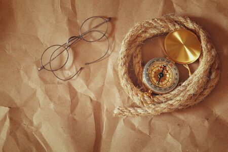 top view of compass, rope, old glasses. explorer and adventure concept. vintage filteredの写真素材
