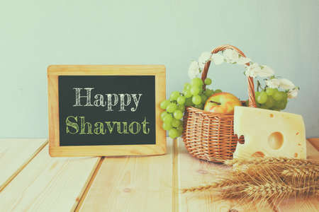 image of dairy products and fruits next to blackboard, on wooden background.の写真素材