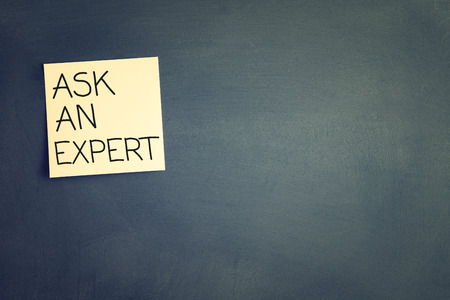 sticky with the note ask an expert over chalkboard. room for textの写真素材