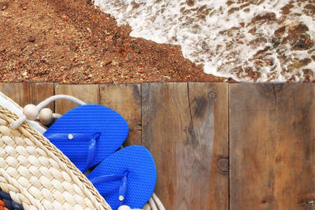 top view of the beach and wooden deck with beach accessories.の写真素材
