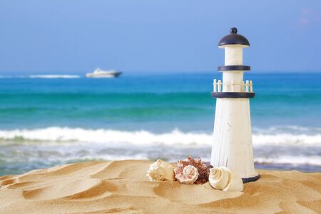 Image of tropical sandy beach, lighthouse and seashells. Summer conceptの写真素材