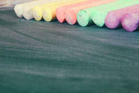 Top view of empty blackboard with colorfull chalks and chalk rubbed textureの写真素材
