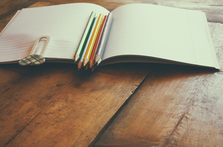 Back to school concept. School supplies on wooden desk. retro filtered. selective focusの写真素材