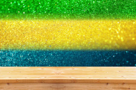 empty table in front of abstract glitter lights using brazil flag colors. Ready for product display