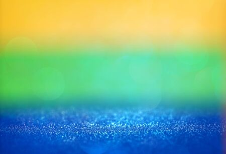 blurry abstract glitter lights background using brazil flag colors. de-focused