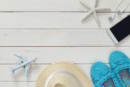 Top view of woman vacation accessories and life style objects on white wooden backgroundの写真素材