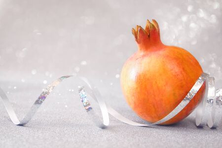 Rosh hashanah (jewesh New Year holiday) concept - pomegranate over glitter background. Traditional symbolの写真素材