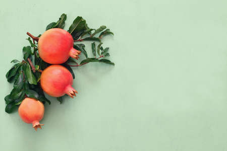 Rosh hashanah (jewish New Year holiday) concept -  pomegranate over wooden table. Traditional symbolの写真素材