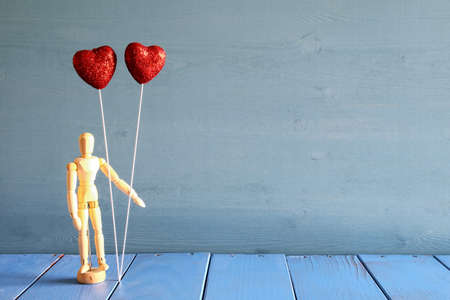 Couple red glitter hearts on wooden tableの写真素材