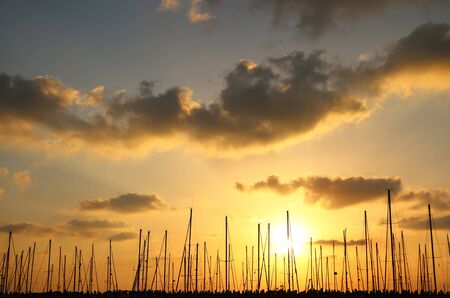Image of gold sunset sky with clouds and yachts at old portの写真素材