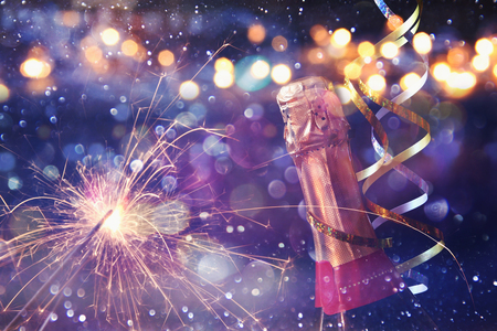 Abstract image of champagne bottle and festive lights. New year and celebration conceptの写真素材