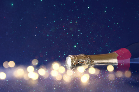 Abstract image of champagne bottle and festive lights. New year and celebration conceptの写真素材