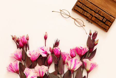 Top view of beautiful pink flowers and vintage objects on white background. Copy spaceの写真素材