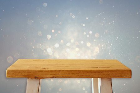 Empty small table in front of glitter background. For product display