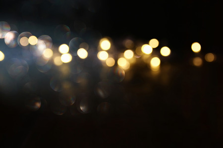 glitter lights background. dark gold and black. de focused.の写真素材