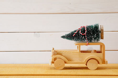 Wooden car carrying a christmas tree.の写真素材