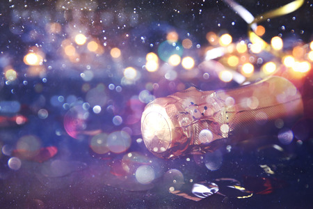 Abstract image of champagne bottle and festive lights. New year and celebration conceptの写真素材