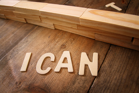 Image of wall between letters I CAN'T, cutting the letter T so it written I CAN. Success and challenge conceptの写真素材