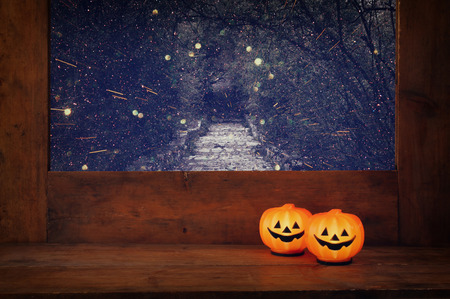 Halloween holiday concept. Cute pumpkins on wooden window sill.の写真素材